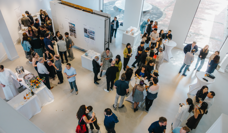 photo of a graduation reception - people scattered in Farish gallery