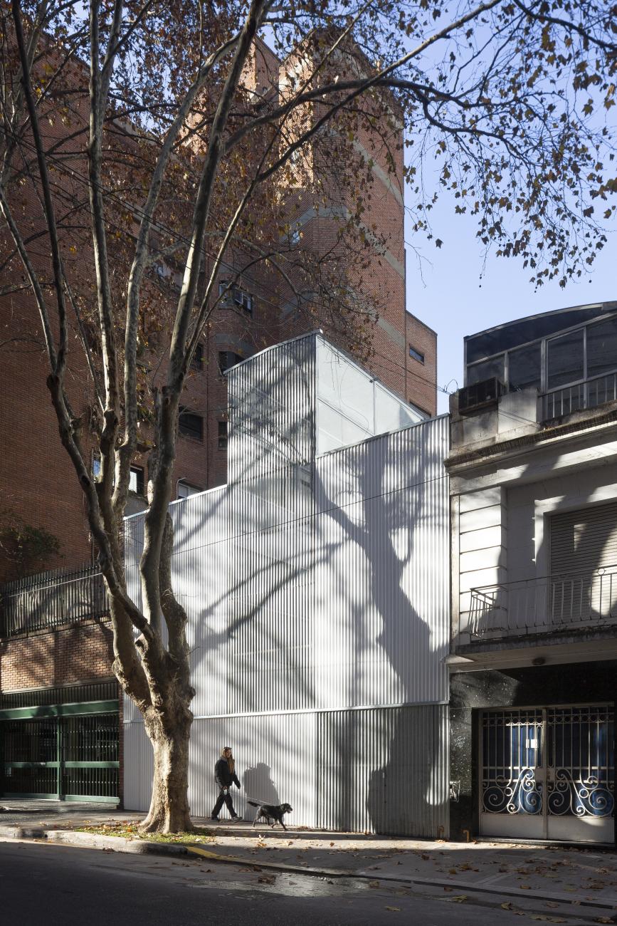 Monolithic white building with a striated facade