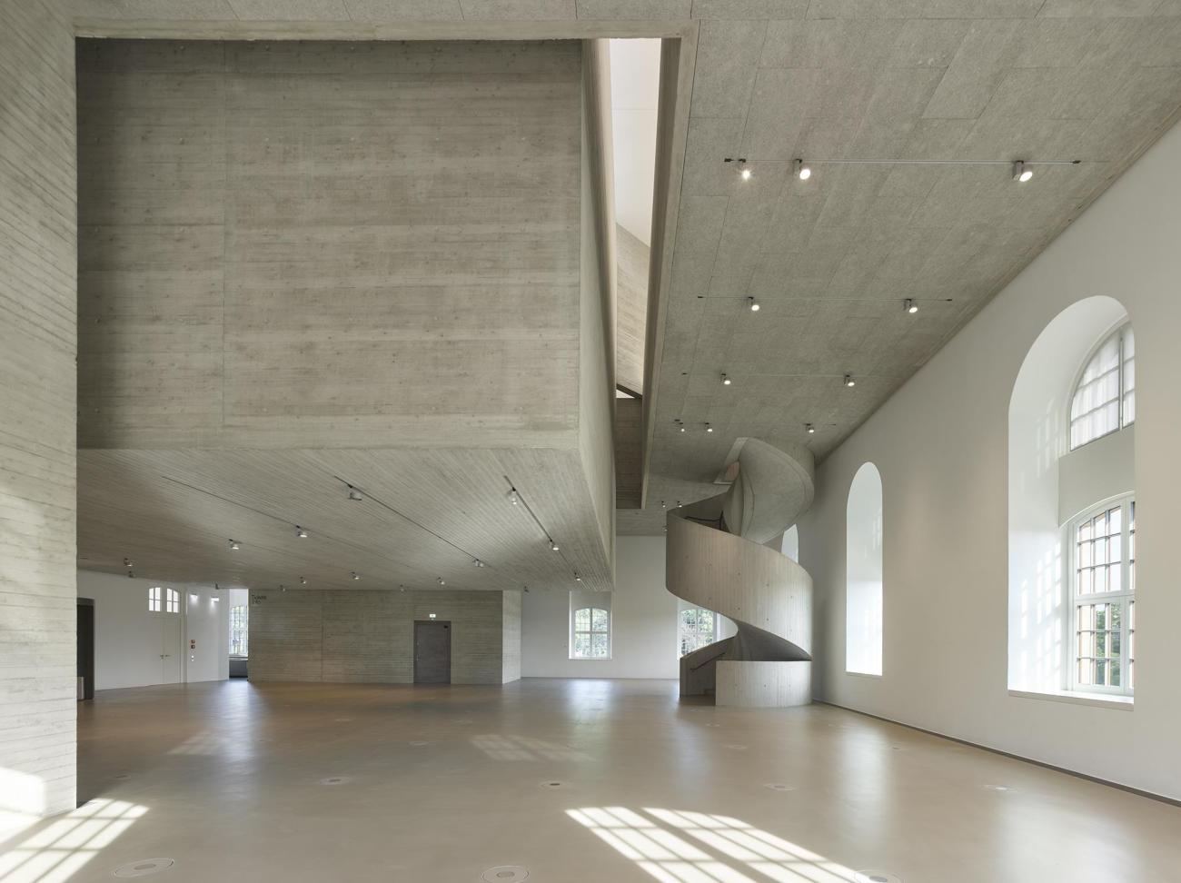 Interior concrete space with statement spiral staircase