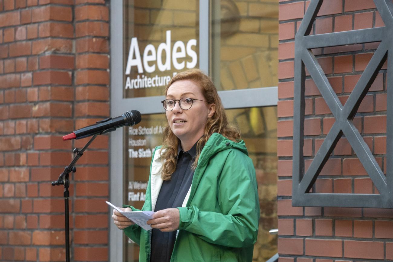 Curator and Assistant Professor Brittany Utting speaks at the exhibition opening