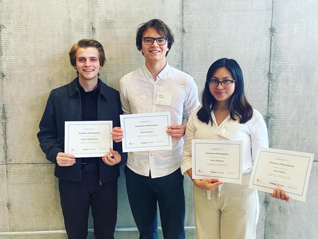 Photo of three students holding their awards from AIA 