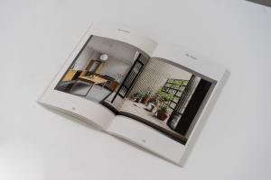 Image of two page spread in book of a buidling project. A home with photos of the interior